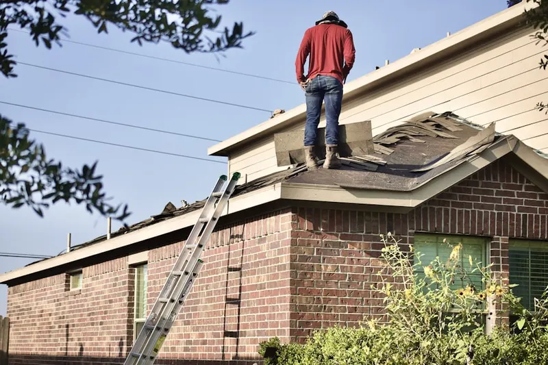 Professional roofer working on a residential roof in Moncure